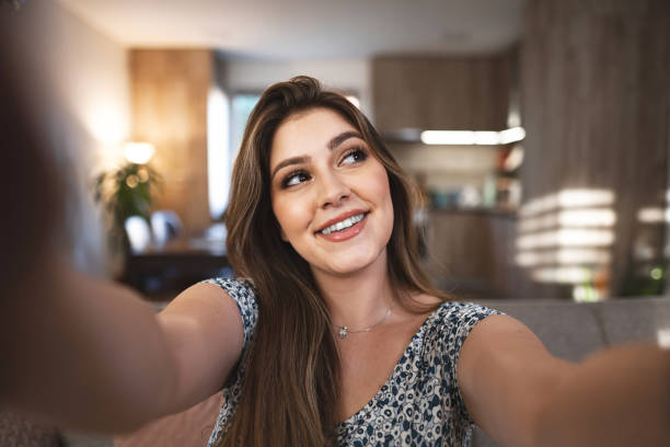 istock Beautiful brunette young woman smiling at camera while looking away 1659578602