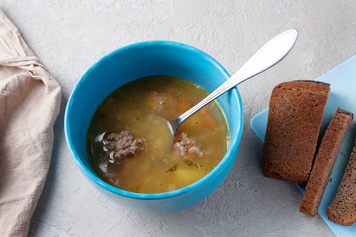 pea soup with meatballs, napkin, bread
