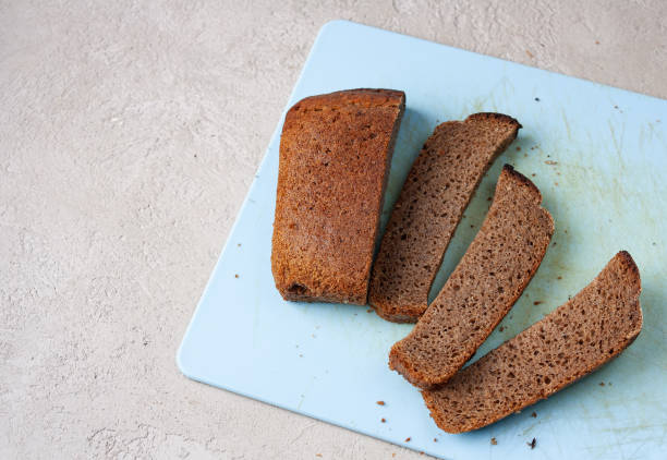 istock loaf of rye bread cut into pieces, copy space 1659617199