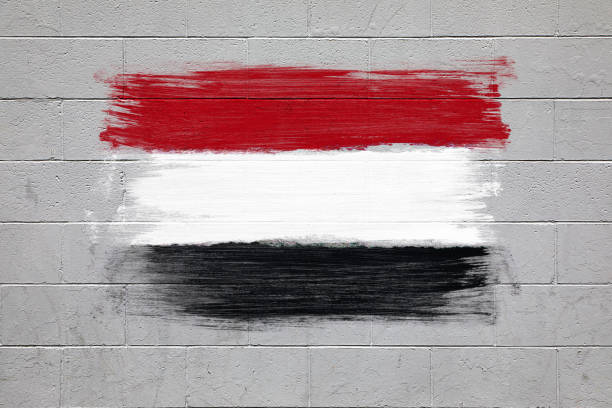 Close up of Yemen flag colors red  black and white painted on a brick wall