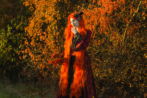 Redhead woman in red gothic dress