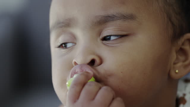 child eating grapes