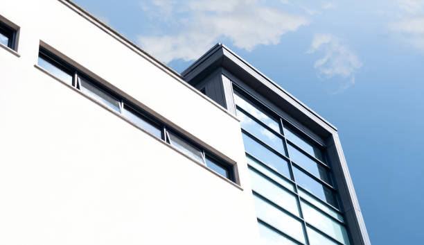 istock Modern building with blue sky and cloud reflection on glass windows in sunny day summer,Corporate concrete building in city. 1659637880