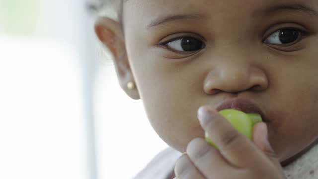 little girl eating grapes