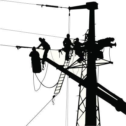 Electricians team silhouette installing power lines in a high voltage electric tower