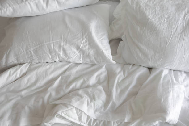 istock messy bed in early morning , messy bed after waking up 1659711580