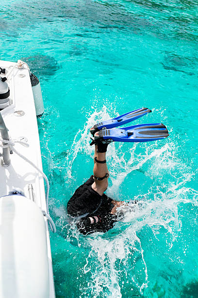 istock diver entering water for a diving excursion in the Caribbean 165972257