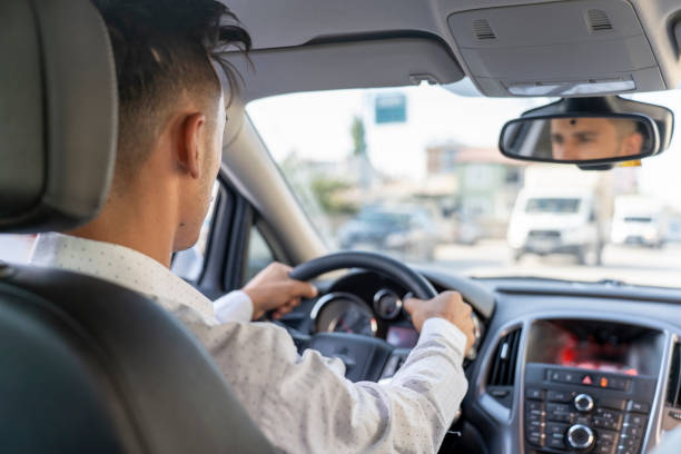 istock Young man driving a car. 1659765303