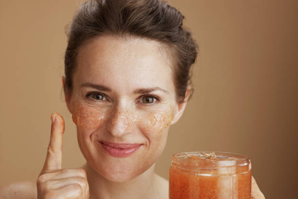 istock happy young woman with face scrub isolated on beige 1659772271