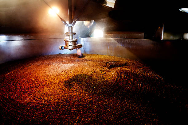 Interior, mash tun and dissolving vat Wooden mash tun and dissolving vats producing beer in a traditional Dorset brewery mixing vat stock pictures, royalty-free photos & images