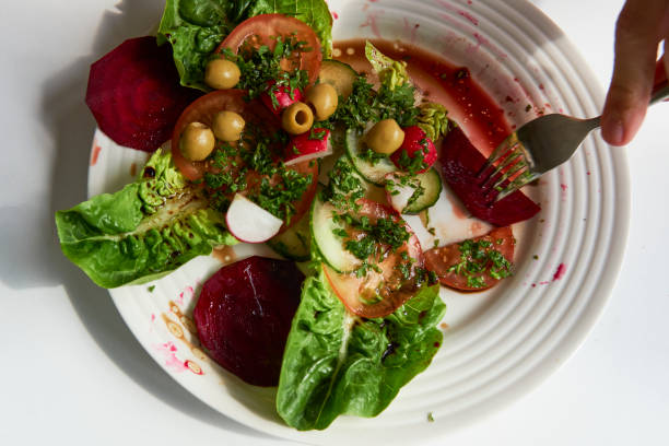 istock Fresh colorful spring vegetable salad with cherry tomatoes and beetroot in green plate. Healthy organic vegan lunch or snack close up. 1659774466