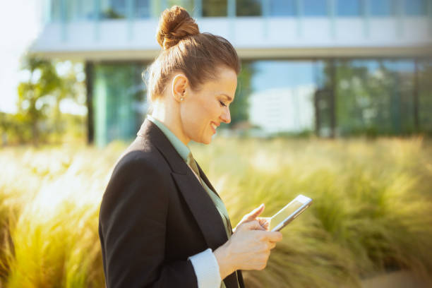 istock smiling woman worker near business center using tablet PC 1659775276