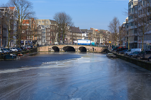 Amsterdam, Netherlands - March 2, 2018: An almost frozen canal in the Dutch capital Amsterdam
