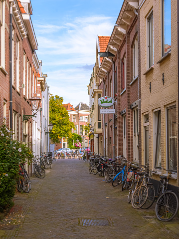 Leiden, Netherlands - September 10, 2016: An empty street in the student city of Leiden with many bicycles leaning against the houses.