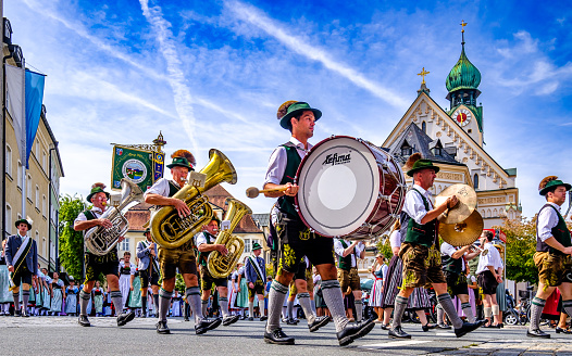 Rosenheim, Germany - September 3: participants at a typical bavarian thanksgiving parade with brass band and traditional clothes in Rosenheim on September 3, 2023
