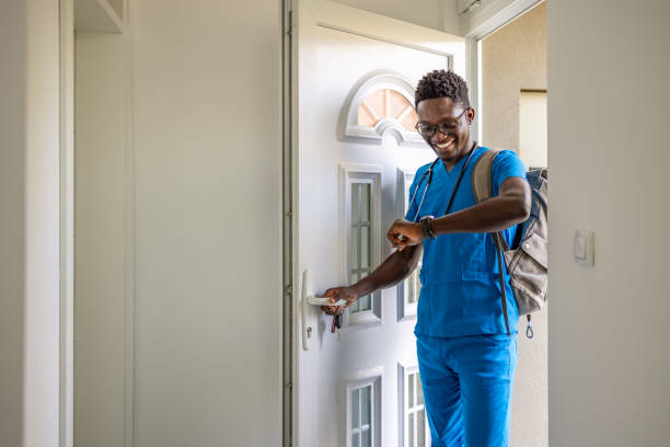 istock A nurse arriving back home and opening the front door. 1659799597