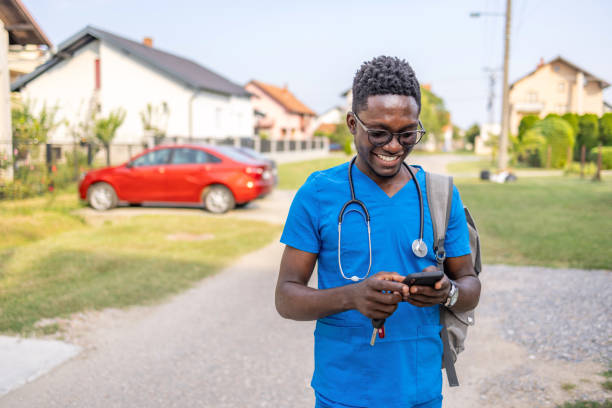 An African nurse using mobile phone for digital banking