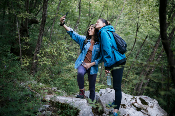 istock Two young female friends taking a selfie while hiking in the forest 1659809671