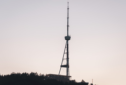 TV tower and funicular complex in Mtatsminda Park in the sunset.