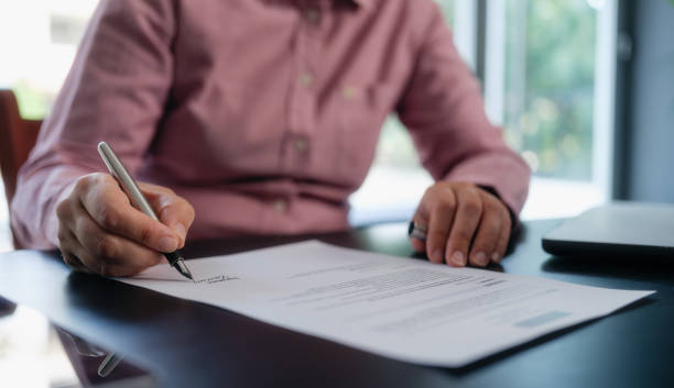 istock businesswoman signing an official document 1659811960
