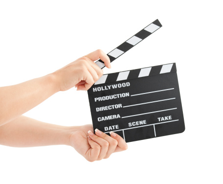 Woman hands holding film clapper isolated on white background