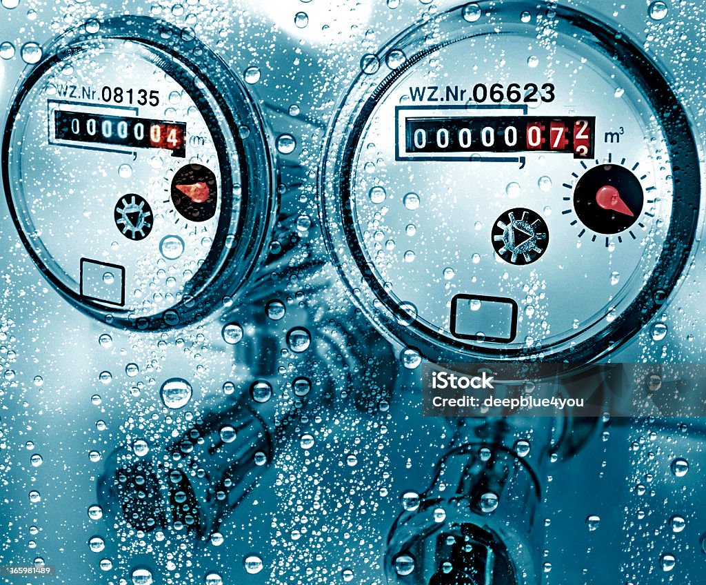 New water counter / meter behind a wet window New water counter behind a wet window. Water meter, close up. isolated industry pipe conduit gauge coupling cold flowing construction pressure meter copper technology service  Water Meter Stock Photo