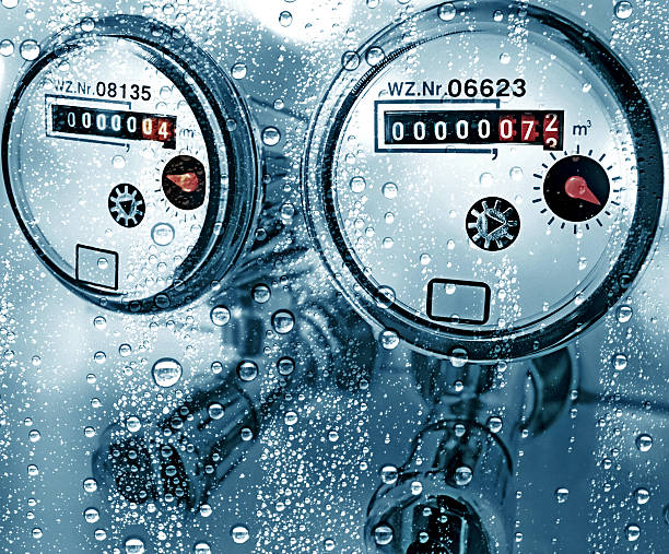 New water counter / meter behind a wet window New water counter behind a wet window. Water meter, close up. isolated industry pipe conduit gauge coupling cold flowing construction pressure meter copper technology service  water conservation photos stock pictures, royalty-free photos & images