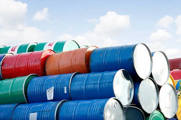 Photo of colorful stacked Barrels in front of the sky