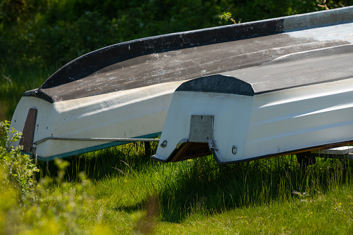 Upside down laid up plastic boats.