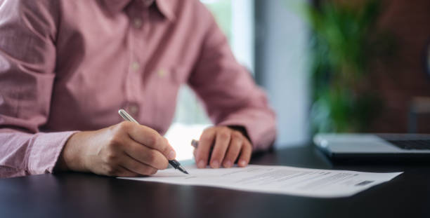 istock businesswoman signing an official document 1659822101