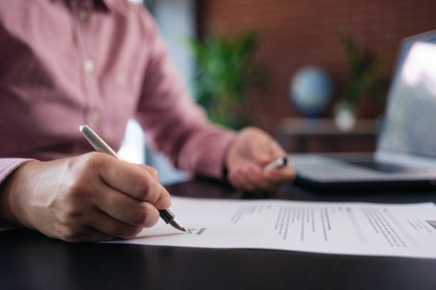 istock businesswoman signing an official document 1659824248