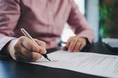 businesswoman signing an official document