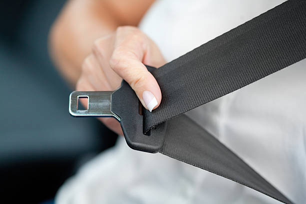Hand pulling seat belt Hand pulling seat belt buckle photos stock pictures, royalty-free photos & images