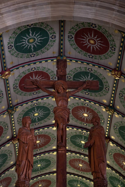 Crucified Jesus Christ on a cross A wooden cross inside a church with a golden-shining fresca in the background what mountain was jesus crucified on stock pictures, royalty-free photos & images