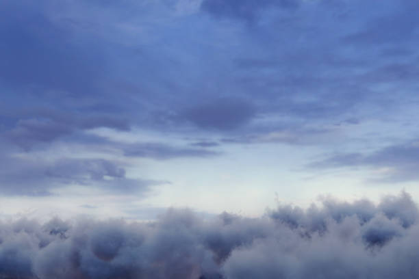 view to soft blue hour sky with fluffy clouds and bright horizon