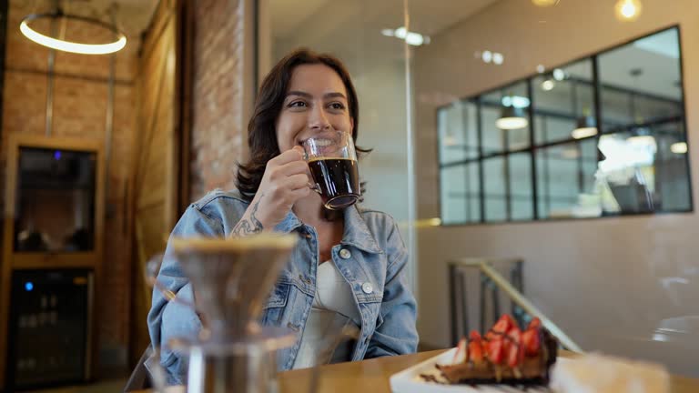 Lesbian couple talking and drinking coffee at coffee shop