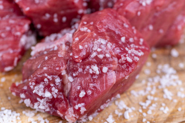 istock sliced piece of fresh raw beef during salting 1659858613