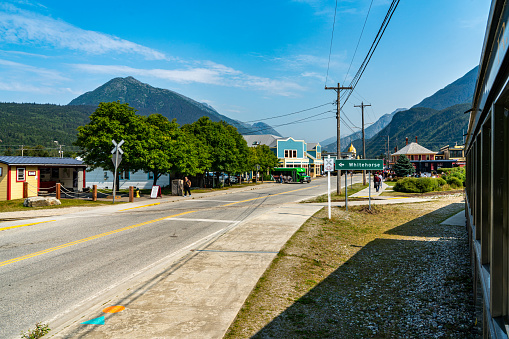 Skagway, Alaska - July 30, 2023: Tourists are walking to downtown for visiting. Skagway townscape and White Pass & Yukon Route Railway in the morning, Alaska, USA.