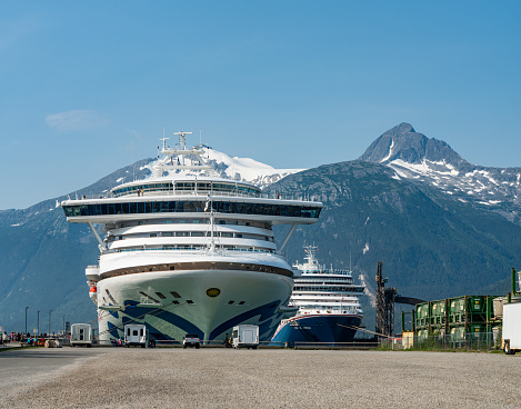 Skagway, Alaska - July 30, 2023: Carnival Luminosa and Sapphire Princess moored at cruise pier in the morning in Skagway, Alaska, USA.