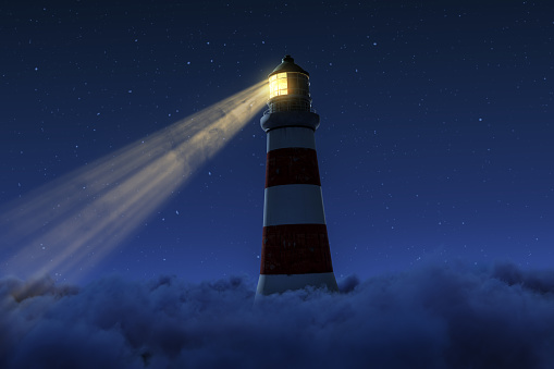 3D rendering of an illuminated lighthouse with long light beam over fluffy clouds at starry night