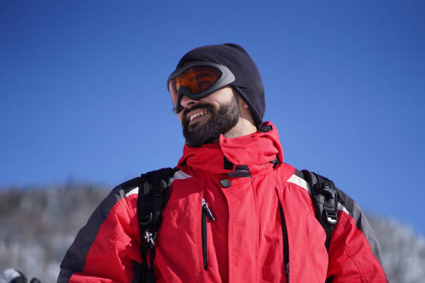 istock Happy man wearing protective ski goggles looking into distance 1659892816