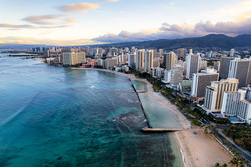 Sunrise panoramic view of the densest parts of Honolulu at Waikiki and its beach and hotels and Diamond Head