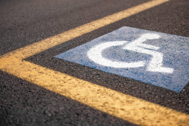 istock Parking sign for disabled on asphalt with yellow lines 1659920921