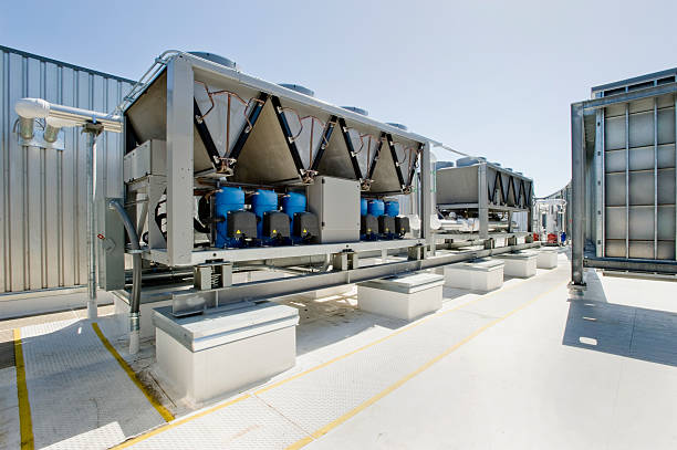 HVAC Installation with Chillers and Compressors Rooftop cooling unit with chiller units and compressors. chiller hvac equipment photos stock pictures, royalty-free photos & images