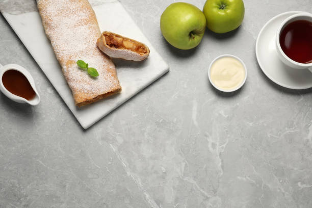 istock Delicious strudel with tasty filling served on light grey marble table, flat lay. Space for text 1659937216