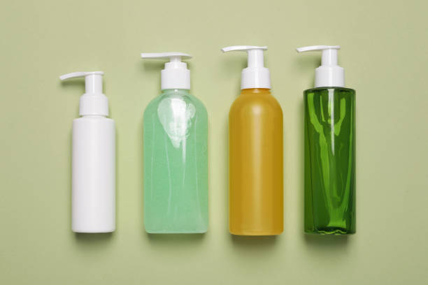 istock Different cleansers on olive background, flat lay with space for text. Cosmetic product 1659939168