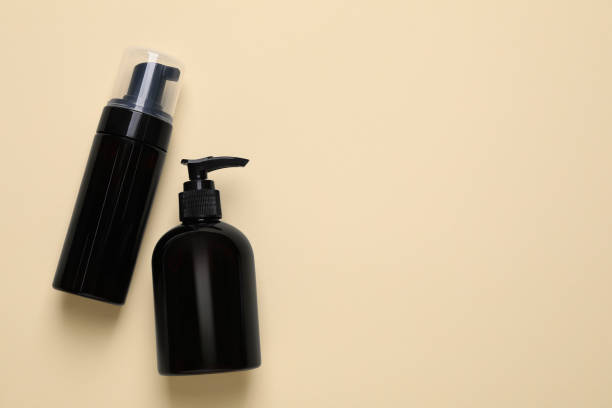 istock Different cleansers on beige background, flat lay with space for text. Cosmetic product 1659939211