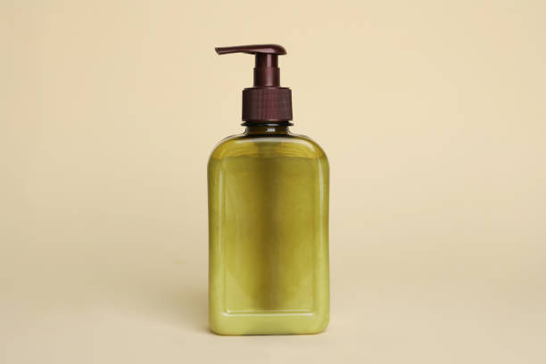istock Bottle of face cleansing product on beige background. Space for text 1659939248