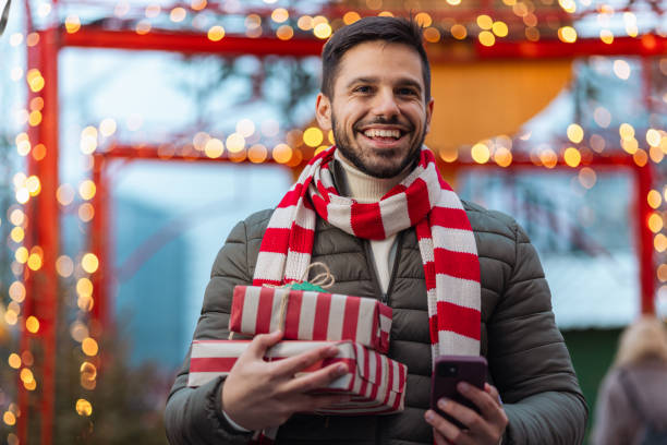 istock Young man celebrating Christmas outdoors 1659939994