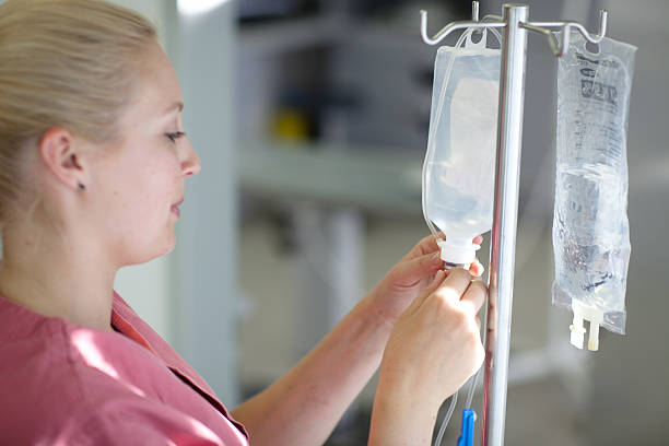 female nurse is preparing an IV Drip stock photo